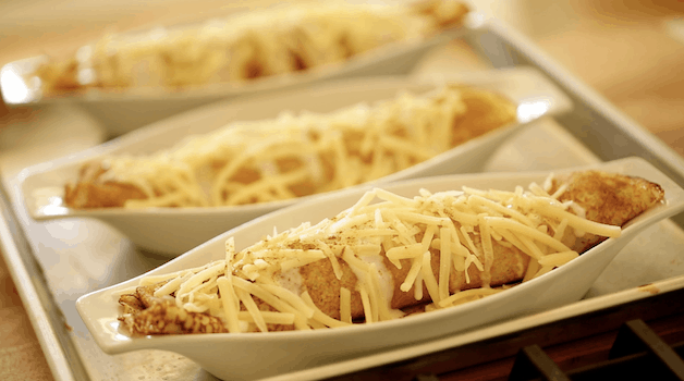 Three crepes in gratin dishes topped with cheese and paprika