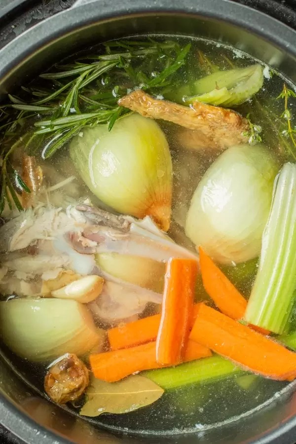 Ingredients for chicken bone broth in a pot