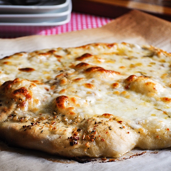 A cheese pizza made with homemade pizza dough.