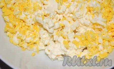 Соединить в одной миске натертые сыр и яйцо.