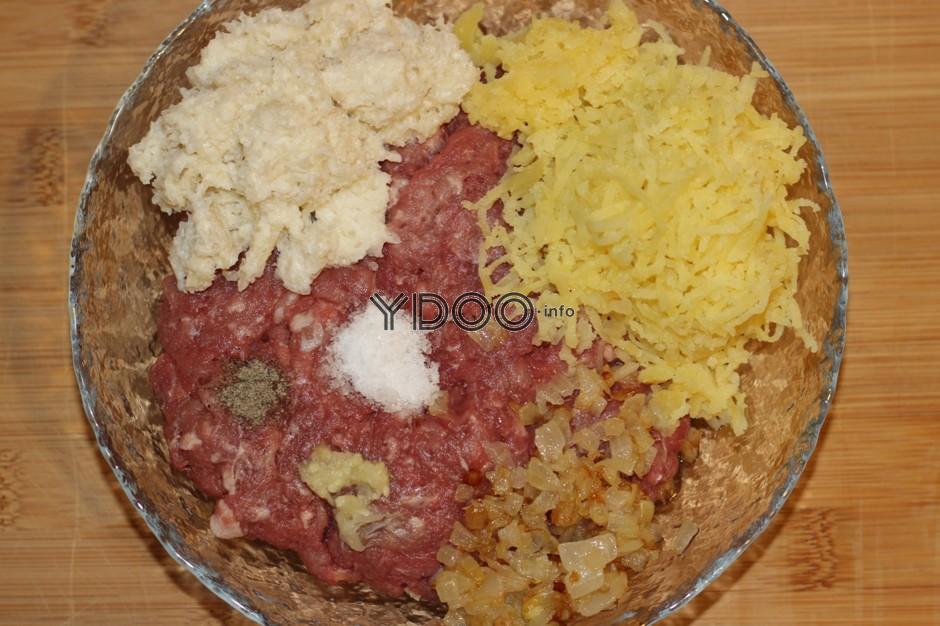 свино-говяжий фарш с тертым вареным картофелем, размоченным мякишем хлеба в молоке, специями в глубокой стеклянной миске на столе